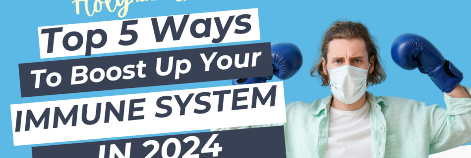 A person wearing a light blue shirt, white t-shirt, and medical mask is posing with blue boxing gloves raised, suggesting readiness. Text on the image reads "Holy Herbology Part 1: Top 5 Ways To Boost Up Your Immune System In 2024" on various overlapping blue and white background shapes.